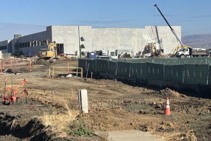 Amazon data center construction sight in Gilroy with construction trucks and a crane.