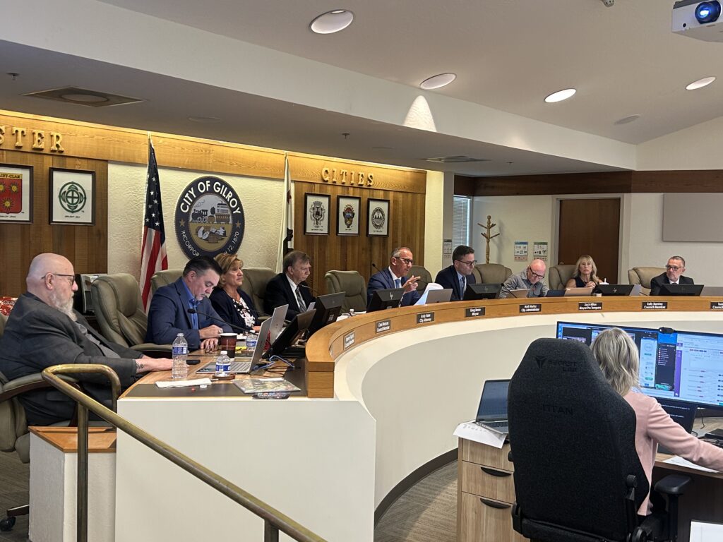 A row of people sitting behind a dais at a government meeting in Gilroy, California