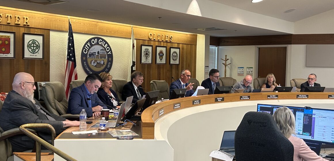 A row of people sitting behind a dais at a government meeting in Gilroy, California