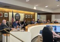 A row of people sitting behind a dais at a government meeting in Gilroy, California
