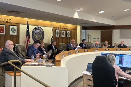 A row of people sitting behind a dais at a government meeting in Gilroy, California
