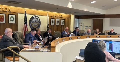 A row of people sitting behind a dais at a government meeting in Gilroy, California