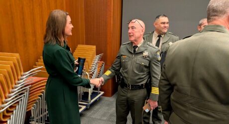Sheriff and Cupertino Mayor A man and woman shaking hands at a government meeting in Cupertino, California