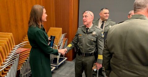 A man and woman shaking hands at a government meeting in Cupertino, California