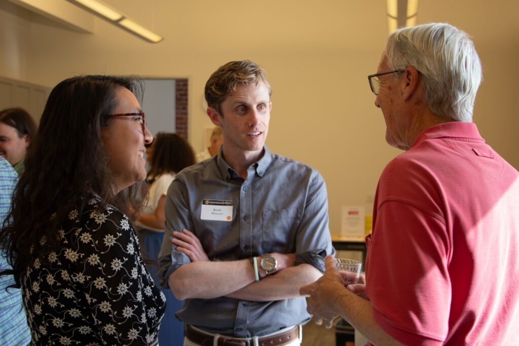 Three people talking at an open house in San Jose, California