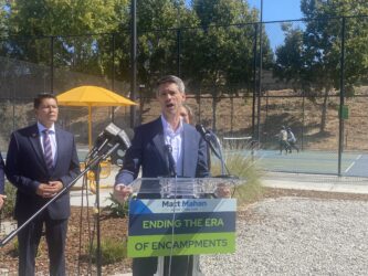 SAN JOSE NEW HOMELESS COUNTING MODEL- MATT MAHAN A man speaking at a podium outside in San Jose, California