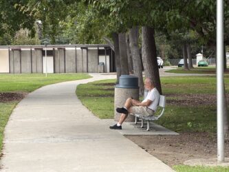 A man sitting on a park bench in Santa Clara, California