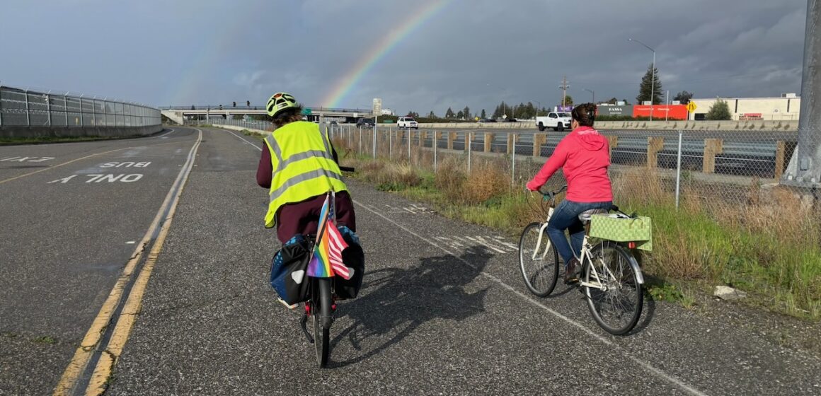 Two people riding bikes on a path in San Jose, California