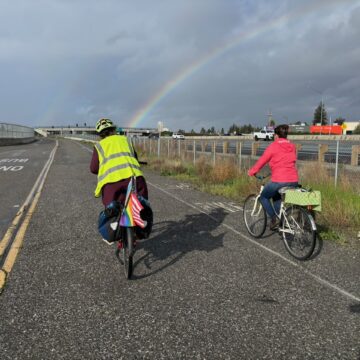Two people riding bikes on a path in San Jose, California
