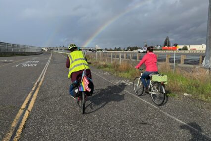 Two people riding bikes on a path in San Jose, California