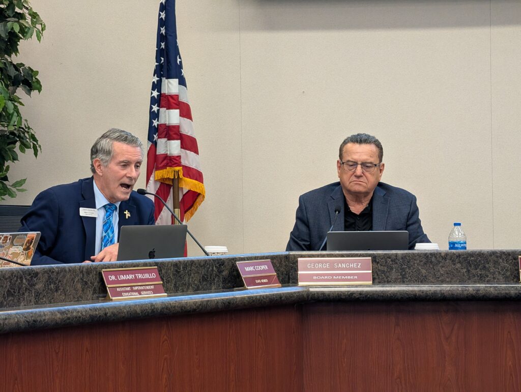 Two men sitting at a dais at a school board meeting in San Jose, California
