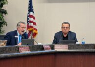 Two men sitting at a dais at a school board meeting in San Jose, California