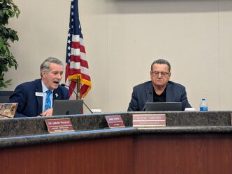 FMSD DISCRIMINATION Two men sitting at a dais at a school board meeting in San Jose, California