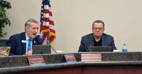 Two men sitting at a dais at a school board meeting in San Jose, California