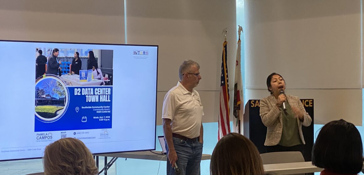 Data center town hall District 2 People conducting a presentation in front of a projector screen