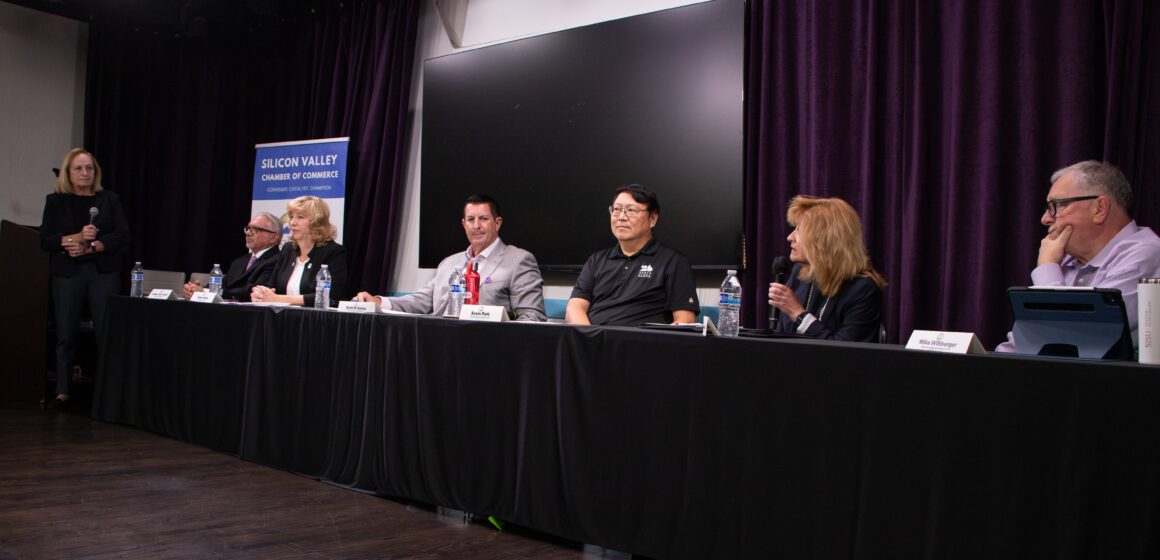 A row of people sitting at a table during an election candidate forum in Santa Clara, California