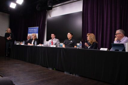 A row of people sitting at a table during an election candidate forum in Santa Clara, California