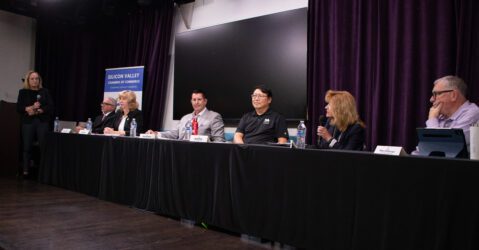 A row of people sitting at a table during an election candidate forum in Santa Clara, California