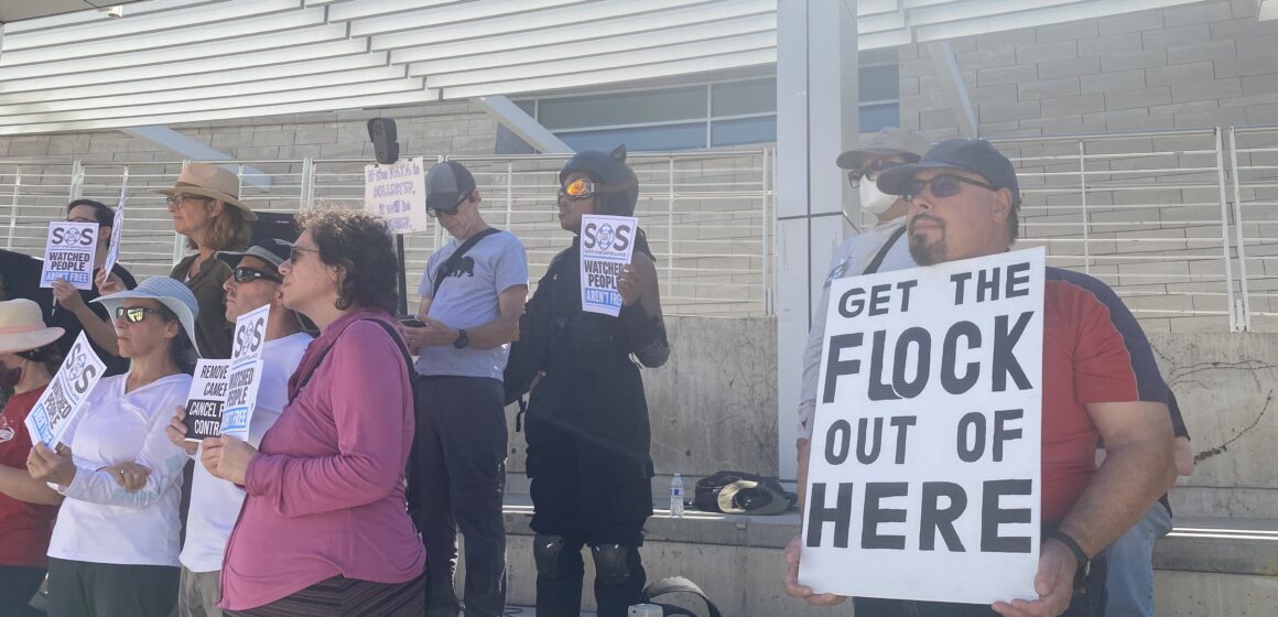 FLOCK CAMERAS RALLY SAN JOSE People holding signs at a rally opposed to automatic license plate readers in San Jose, California