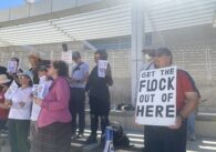 People holding signs at a rally opposed to automatic license plate readers in San Jose, California