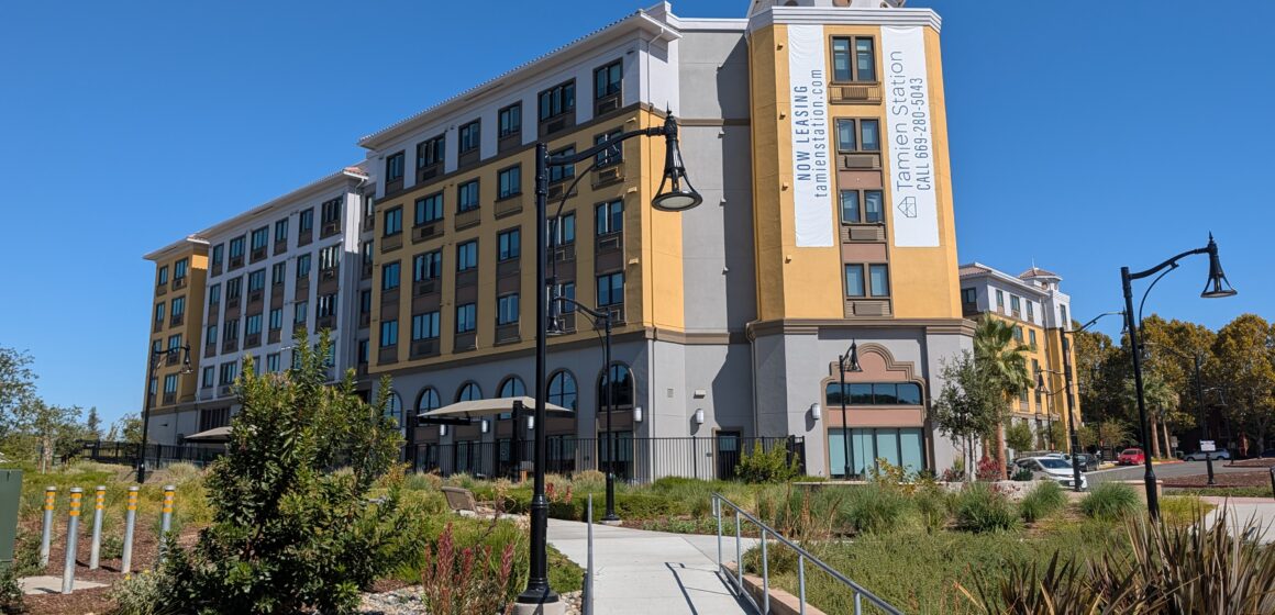 The exterior of an apartment complex near public transit in San Jose, California