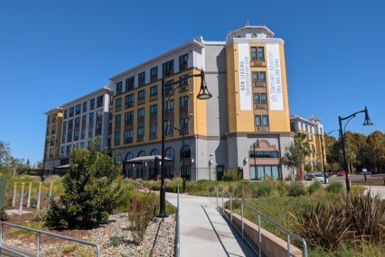 The exterior of an apartment complex near public transit in San Jose, California