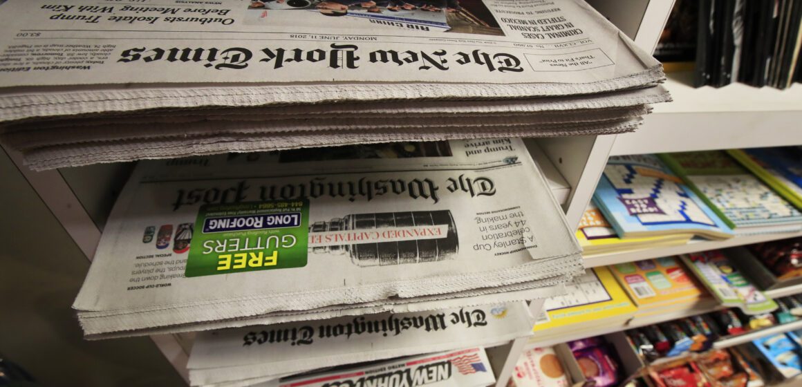 A stack of newspapers in a media rack