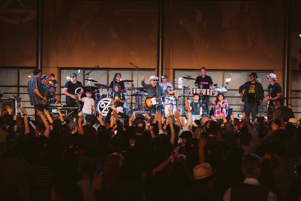 A band on a stage playing in front of a crowd in San Jose, California