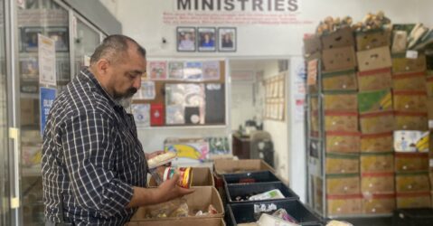 A man looking at produce at a food pantry in San Jose, California
