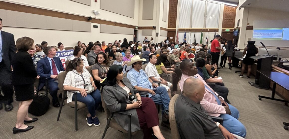 Gilroy City Council meeting attendees crowd of people sitting down in a room looking forward.