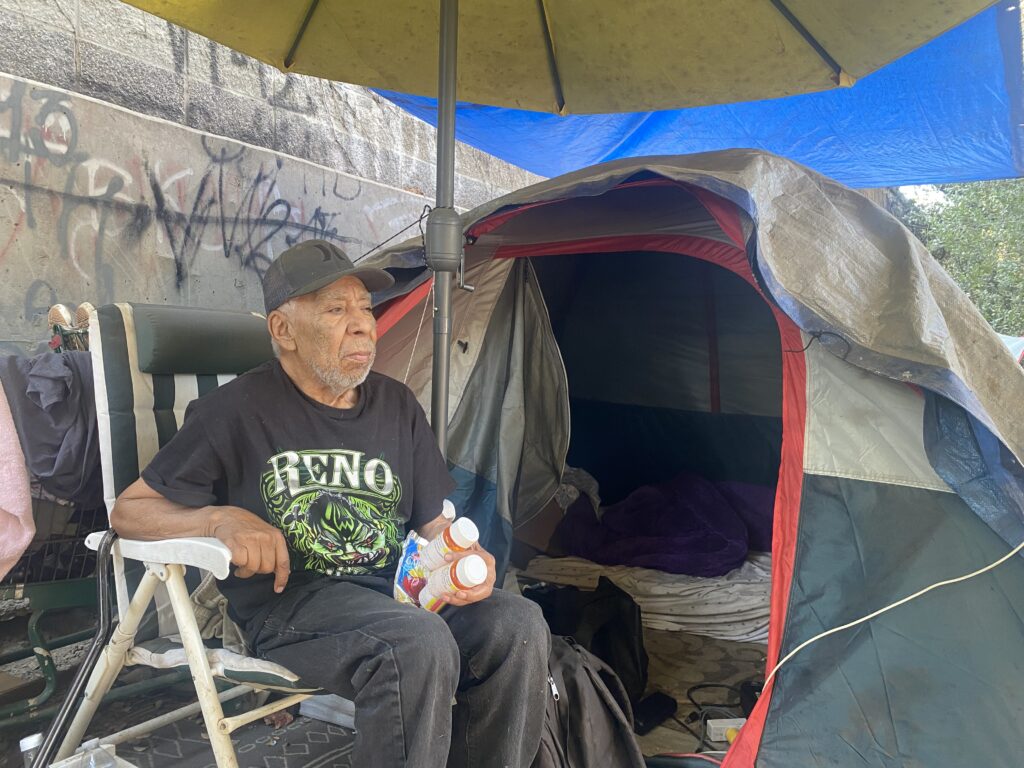 An elderly homeless man in a San Jose homeless encampment