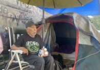 An elderly homeless man in a San Jose homeless encampment