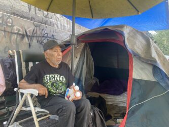 An elderly homeless man in a San Jose homeless encampment