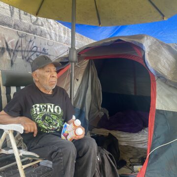An elderly homeless man in a San Jose homeless encampment