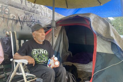 An elderly homeless man in a San Jose homeless encampment