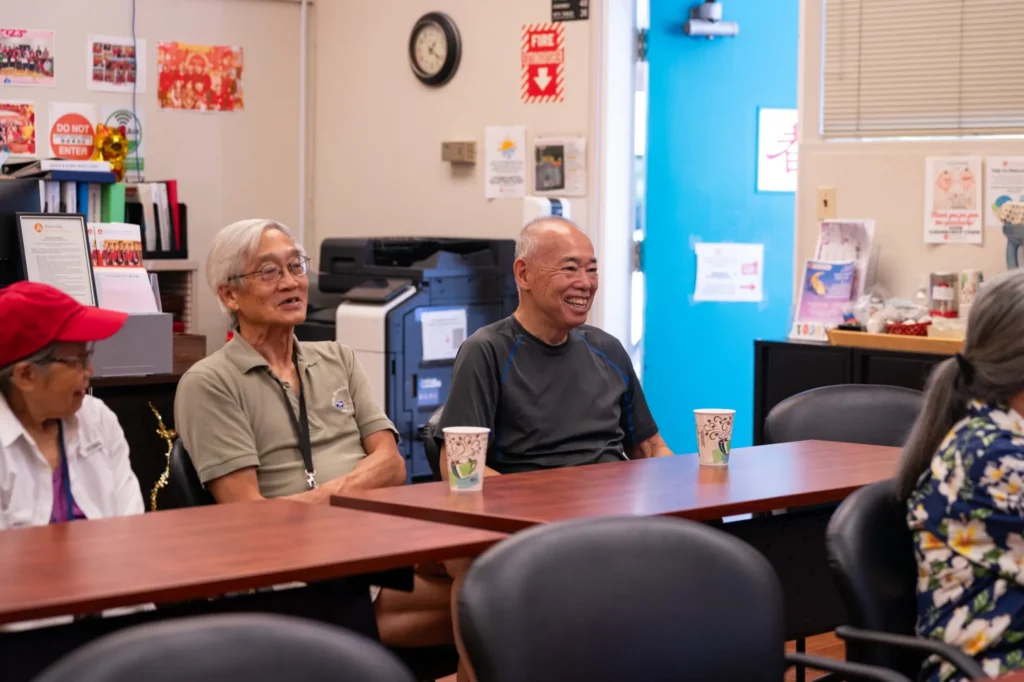 People sitting at a table in a community center in Palo Alto, California