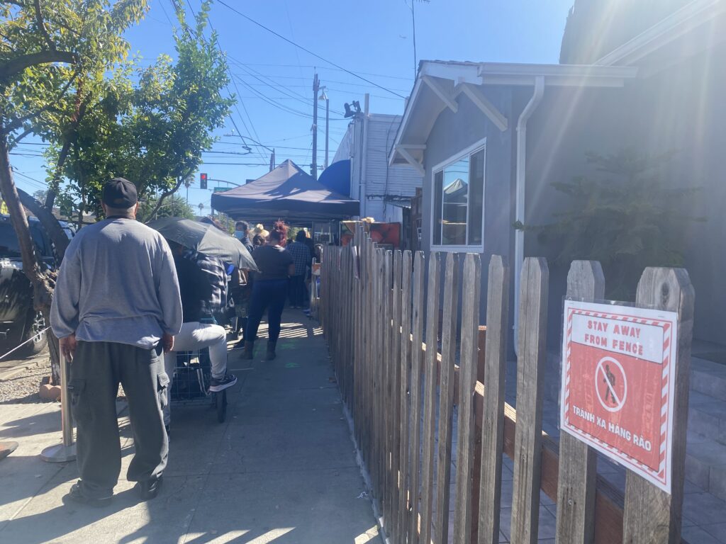 People waiting in line at a food pantry in San Jose, California