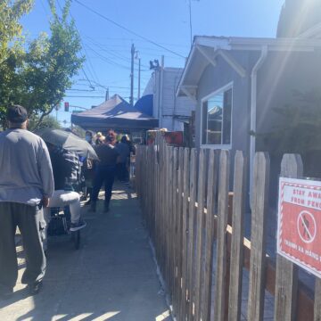 People waiting in line at a food pantry in San Jose, California