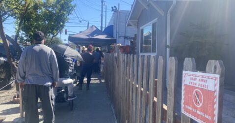 People waiting in line at a food pantry in San Jose, California