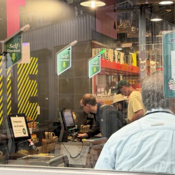 Self-checkout aisles Shoppers scan goods in a self-checkout line.