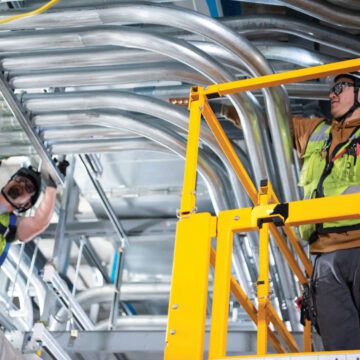 Two electricians working on a job