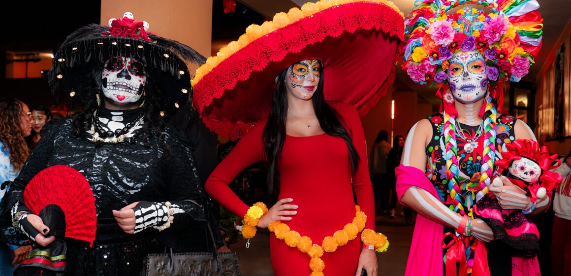 Three women dressed at Catrinas for a Dia De Los Muertos event in San Jose, California