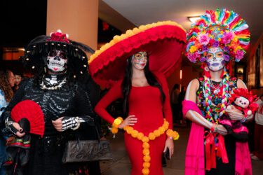 Three women dressed at Catrinas for a Dia De Los Muertos event in San Jose, California