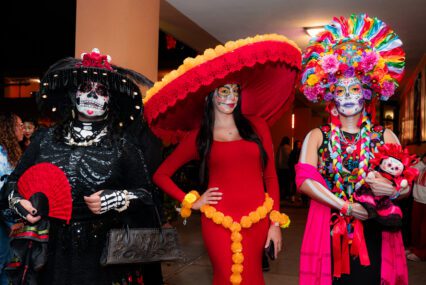 Three women dressed at Catrinas for a Dia De Los Muertos event in San Jose, California