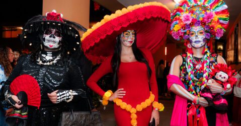 Three women dressed at Catrinas for a Dia De Los Muertos event in San Jose, California