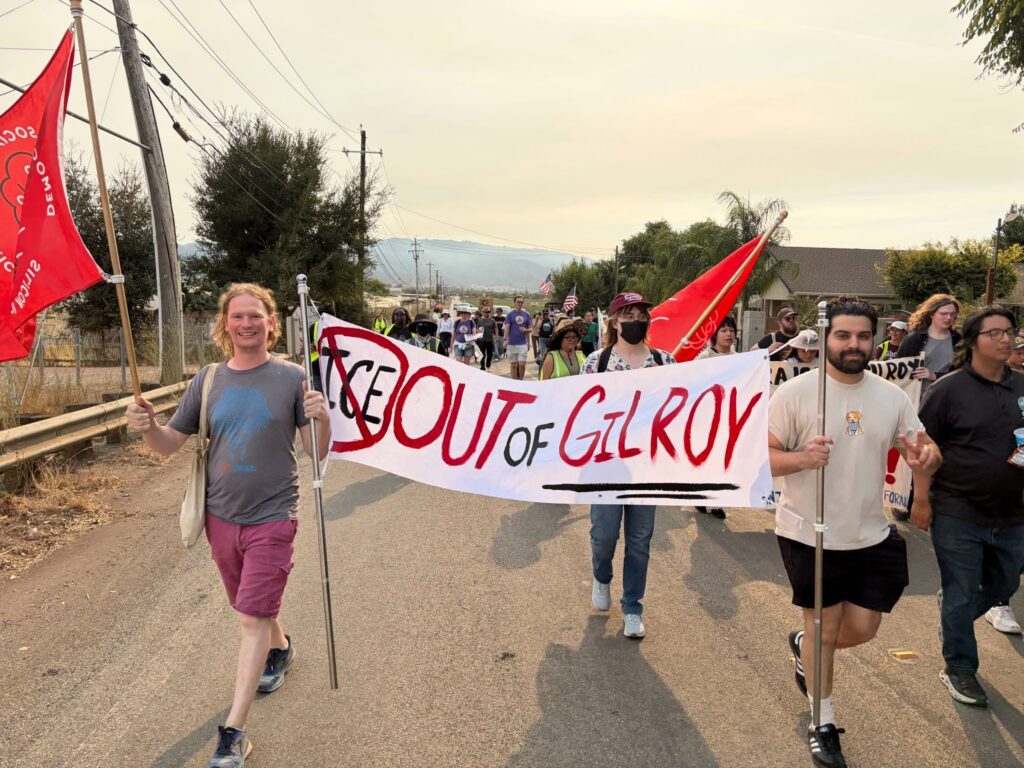 People hold banners and march down the street.