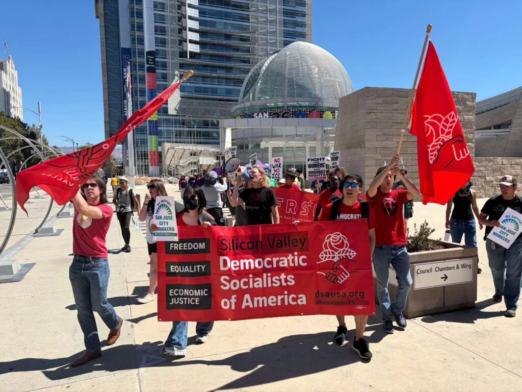 Rallygoers advance in front of San Jose City Hall.