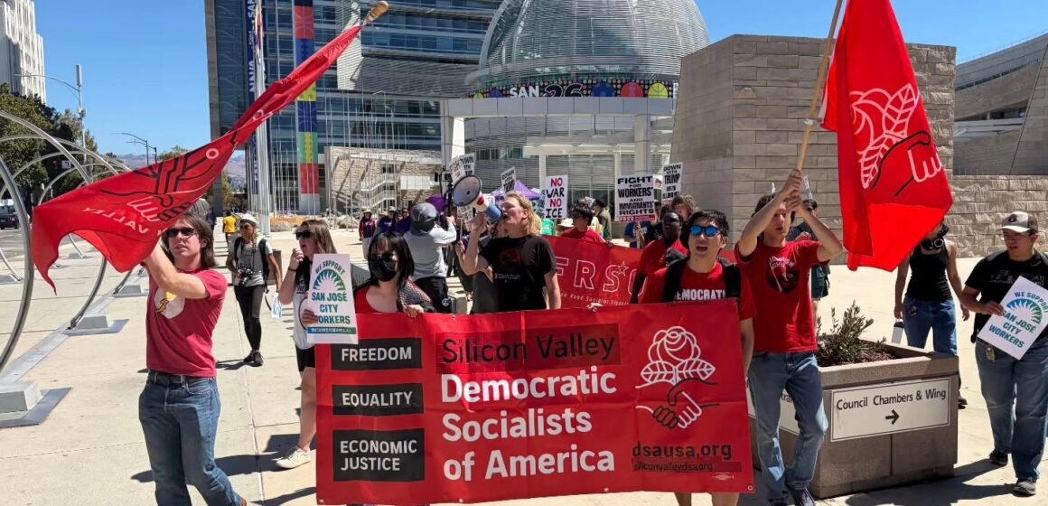 Silicon Valley DSA San Jose Rallygoers advance in front of San Jose City Hall.