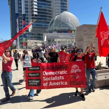 Silicon Valley DSA San Jose Rallygoers advance in front of San Jose City Hall.