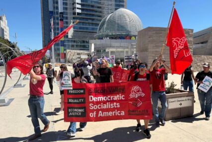 Silicon Valley DSA San Jose Rallygoers advance in front of San Jose City Hall.